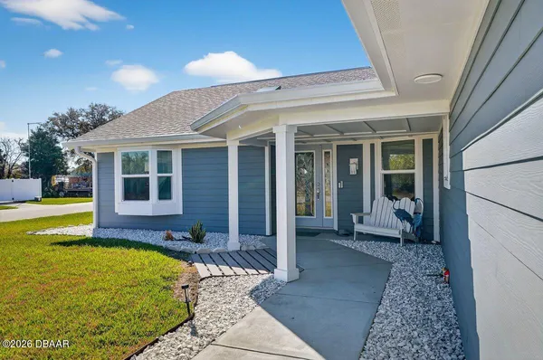 a house view with a seating space and garden
