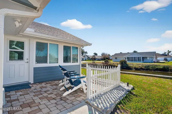 a view of a roof deck with chair and wooden floor
