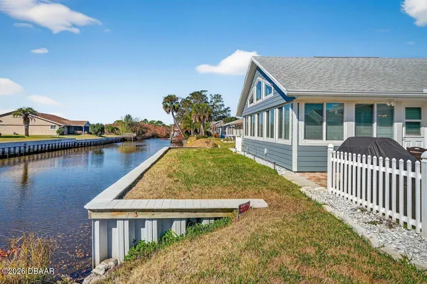 a view of a house with backyard and sitting area