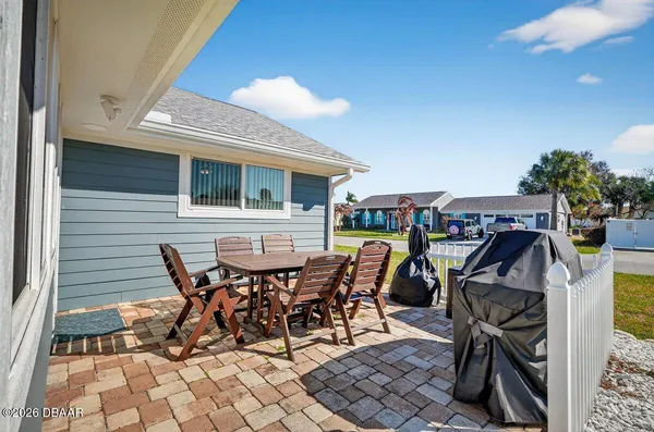 a view of a patio with table and chairs