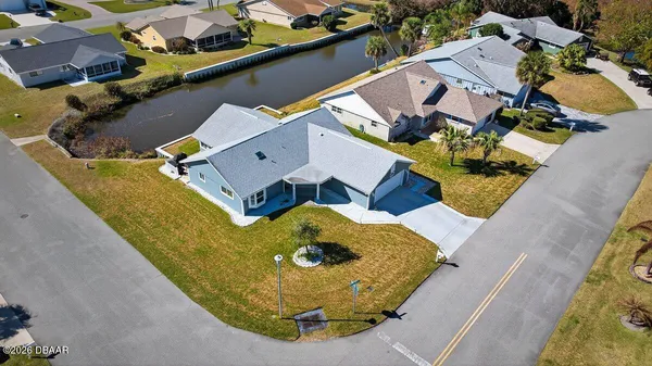 an aerial view of a house with a swimming pool