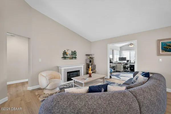 a living room with furniture fireplace and a table