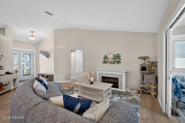 a living room with furniture a fireplace and a flat screen tv