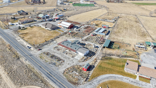 718 South State Street Genola, UT 84655 - Photo 10 of 19 Extensive property featuring multiple outbuildings, fenced enclosures, and a paved road frontage