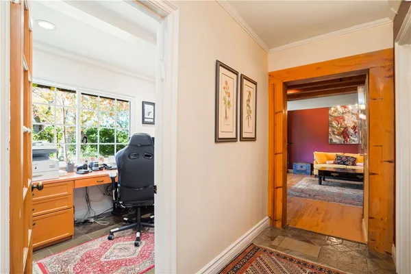 a kitchen with a refrigerator and countertop cabinets