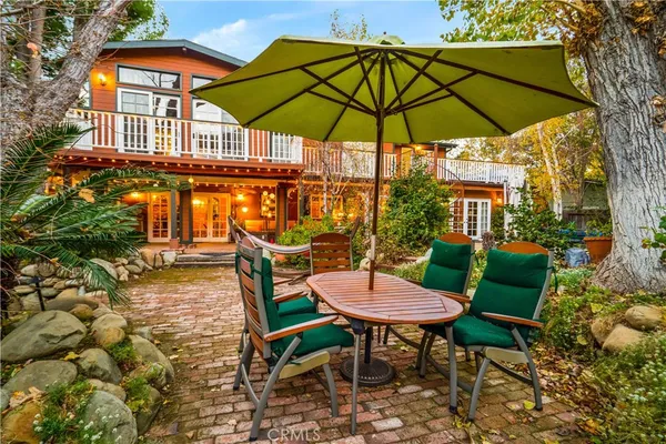 a bed sitting in a yard with wooden fence