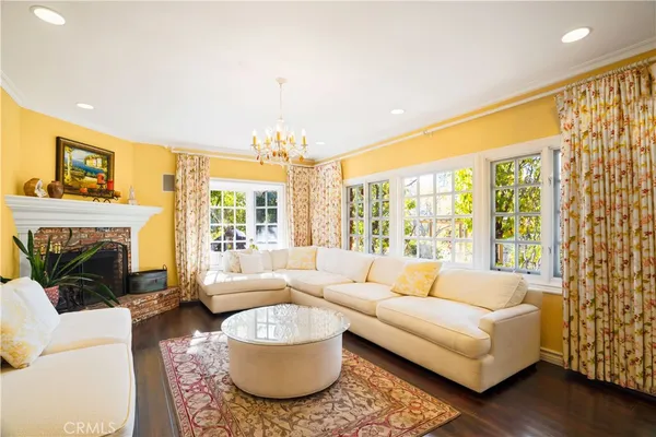 a living room with furniture a fireplace and a large window