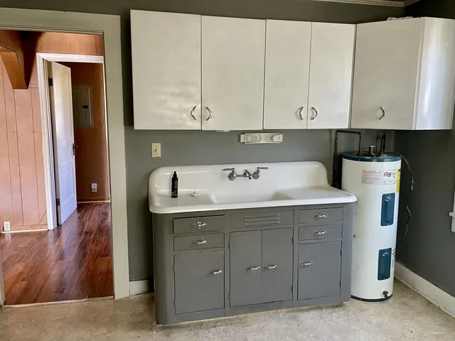 a room with a sink and cabinets