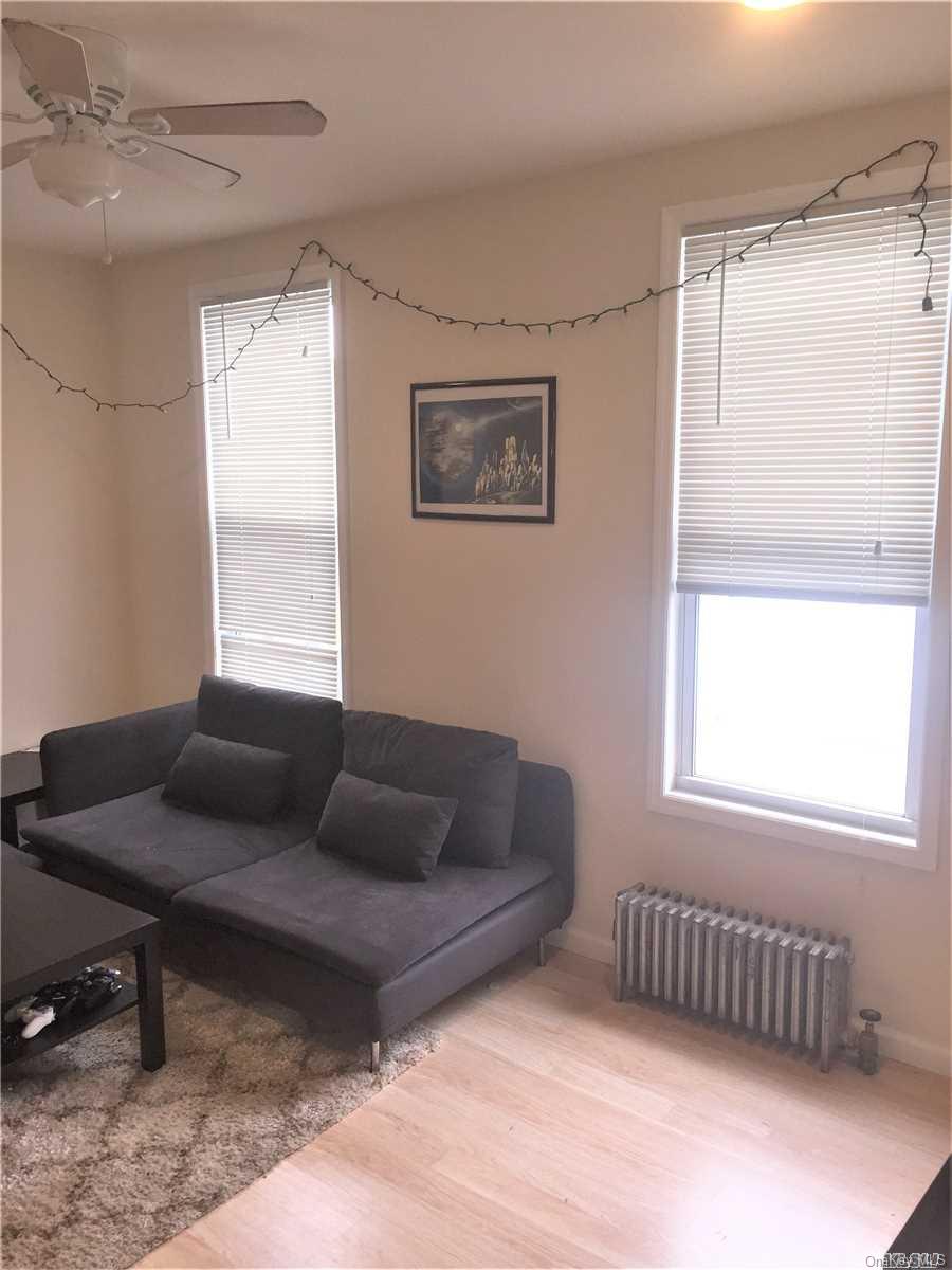 52-05 35th Street, Unit 2 Queens, NY 11101 - Photo 12 of 20 a living room with furniture and a window