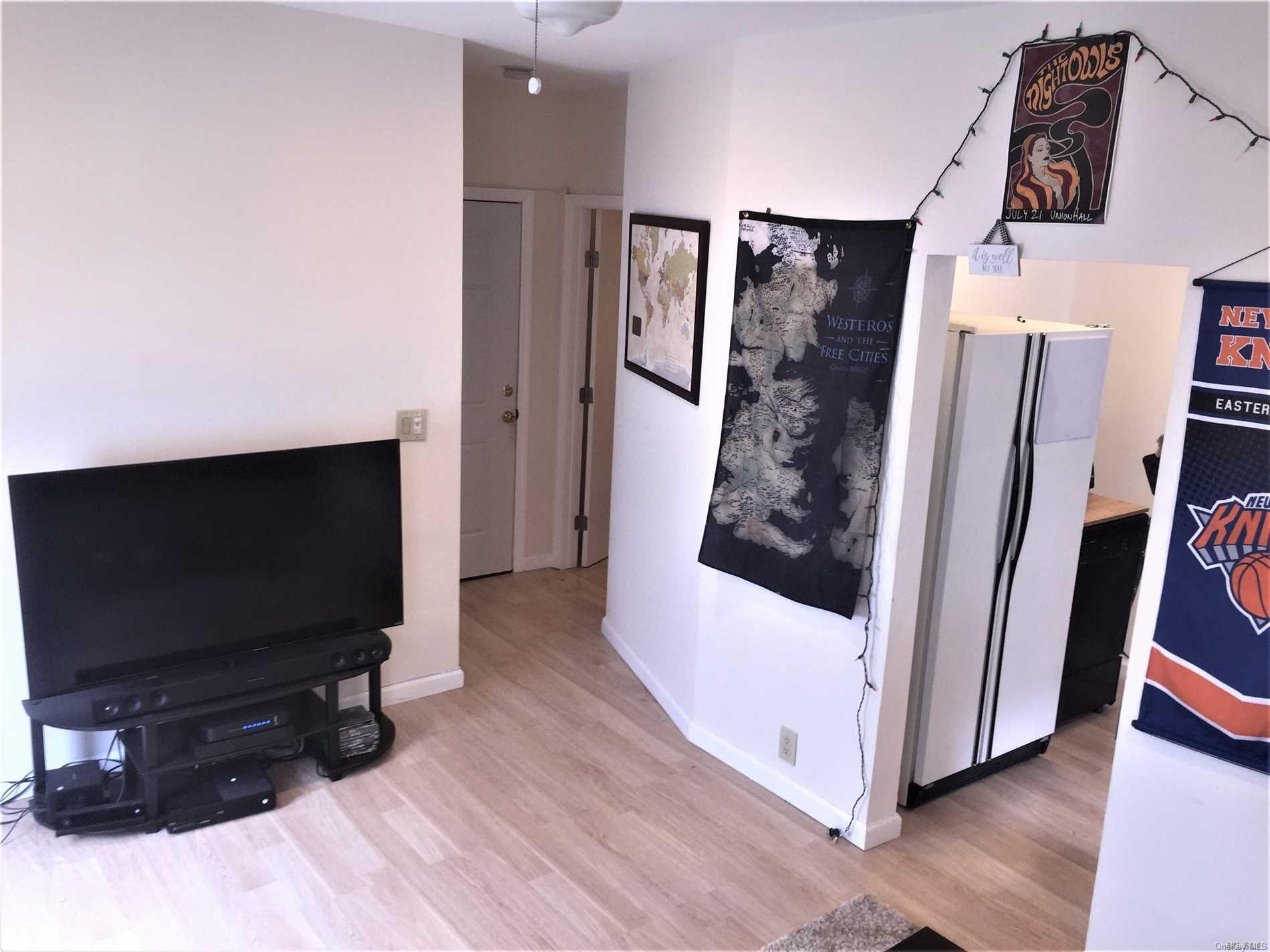 52-05 35th Street, Unit 2 Queens, NY 11101 - Photo 15 of 20 a living room with furniture and a flat screen tv