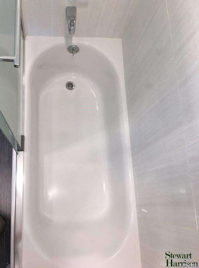 52-05 35th Street, Unit 2 Queens, NY 11101 - Photo 19 of 20 a bathroom with a bathtub