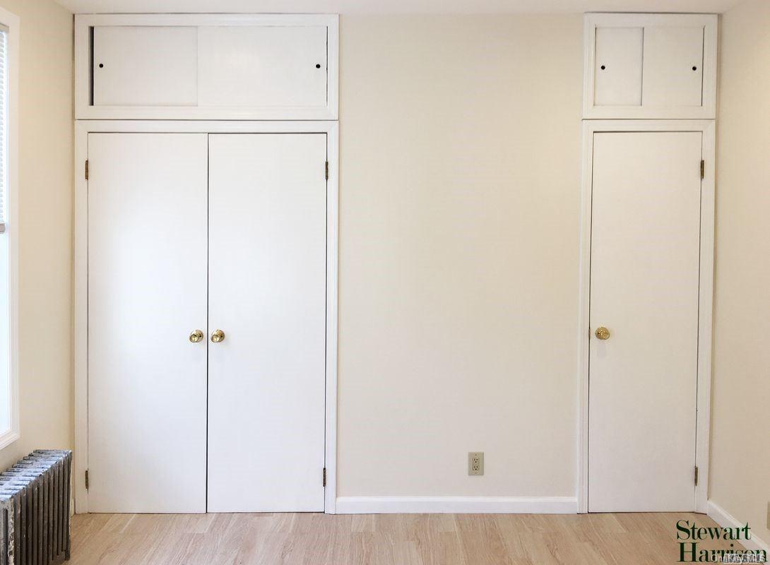 52-05 35th Street, Unit 2 Queens, NY 11101 - Photo 5 of 20 a view of a kitchen with white cabinets and wooden floor