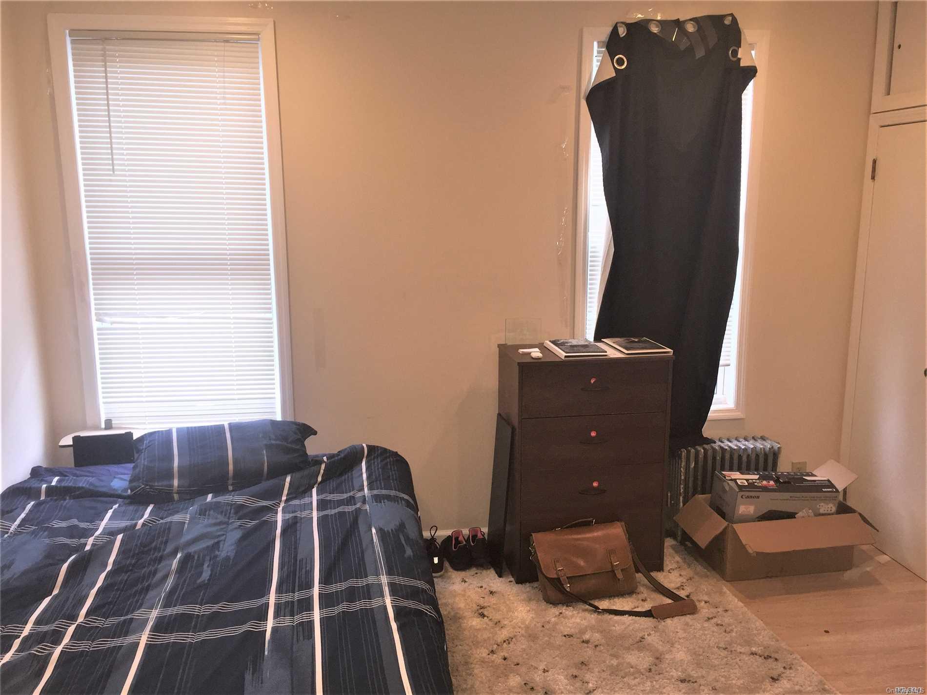 52-05 35th Street, Unit 2 Queens, NY 11101 - Photo 6 of 20 a room with a bed and a window