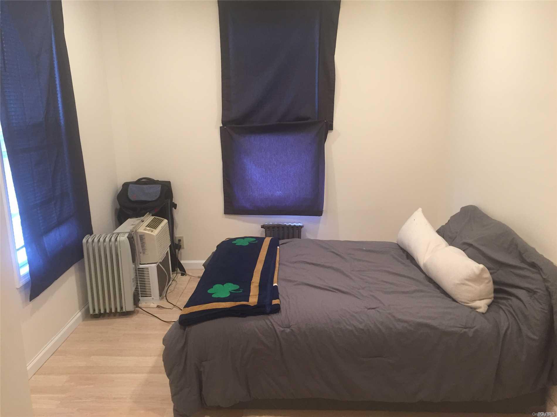 52-05 35th Street, Unit 2 Queens, NY 11101 - Photo 8 of 20 a bedroom with a bed and wooden floor