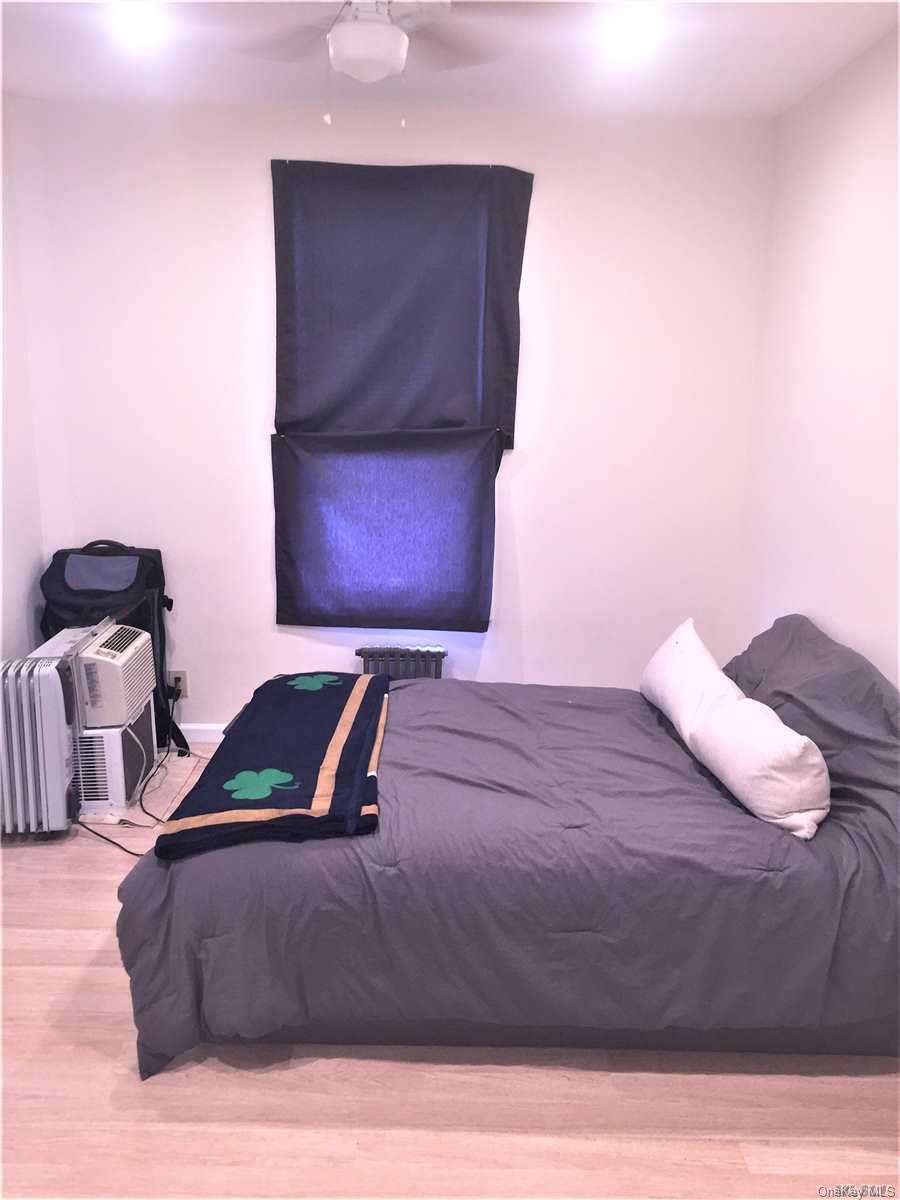 52-05 35th Street, Unit 2 Queens, NY 11101 - Photo 9 of 20 a bedroom with a bed and window