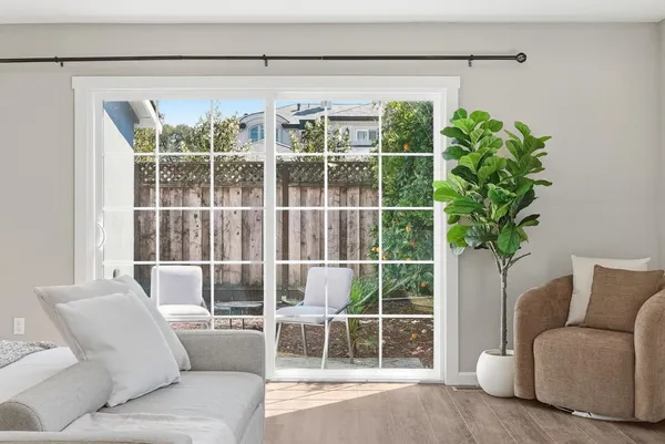 a living room with furniture and a potted plant