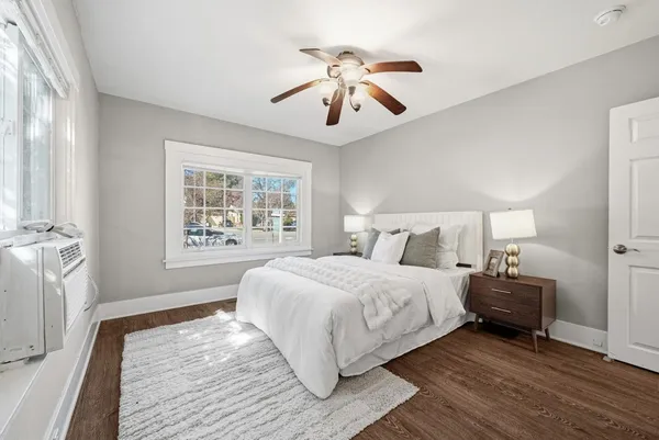 a spacious bedroom with a large bed and a chandelier