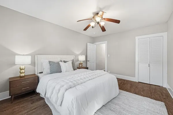 a spacious bedroom with a bed and a chandelier