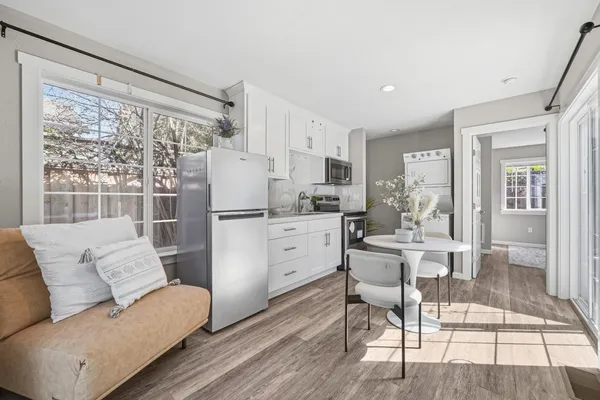 a living room with white furniture and a table