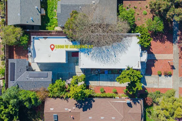 an aerial view of a house with a yard and potted plants