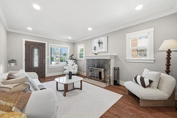 a living room with furniture and a fireplace