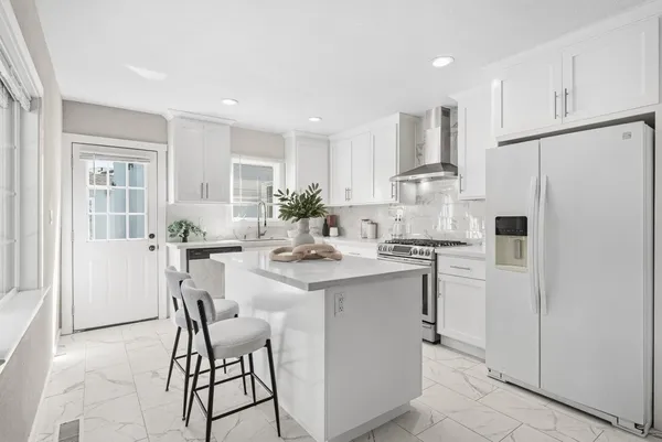 a kitchen with kitchen island cabinets and refrigerator