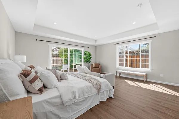 a large bed sitting in a bedroom next to a window and a chair
