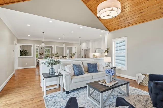 a dining room with furniture and wooden floor