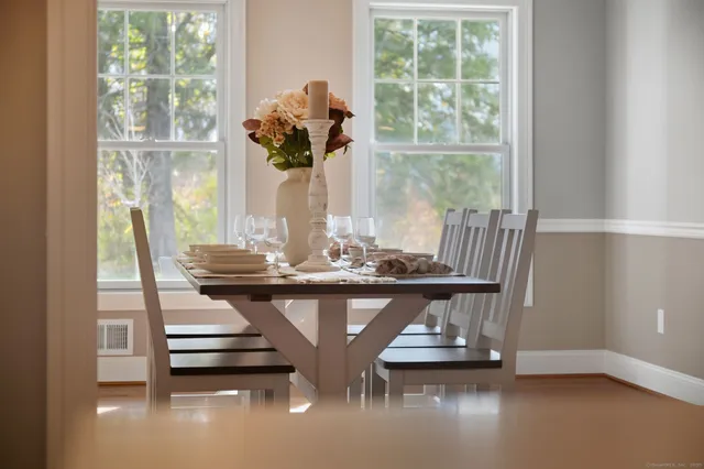 a view of a dining room with furniture window and wooden floor