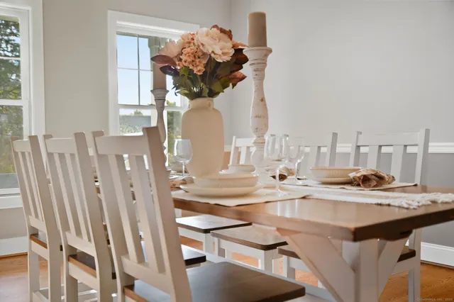 a view of a dining room with furniture and wooden floor