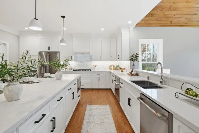 a kitchen with sink stove and cabinets