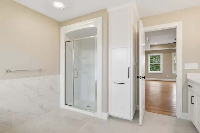 a bedroom with a large bed and a ceiling fan