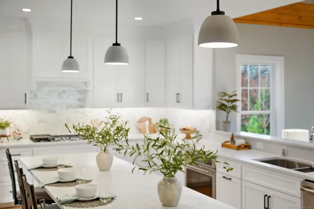 a white bath tub sitting in a bathroom next to a window