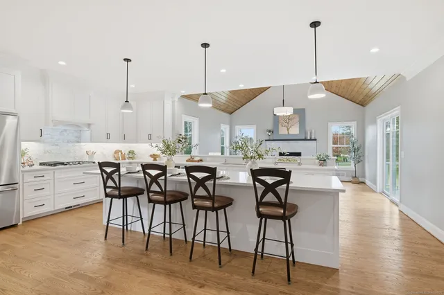 a kitchen with a stove a sink and cabinets