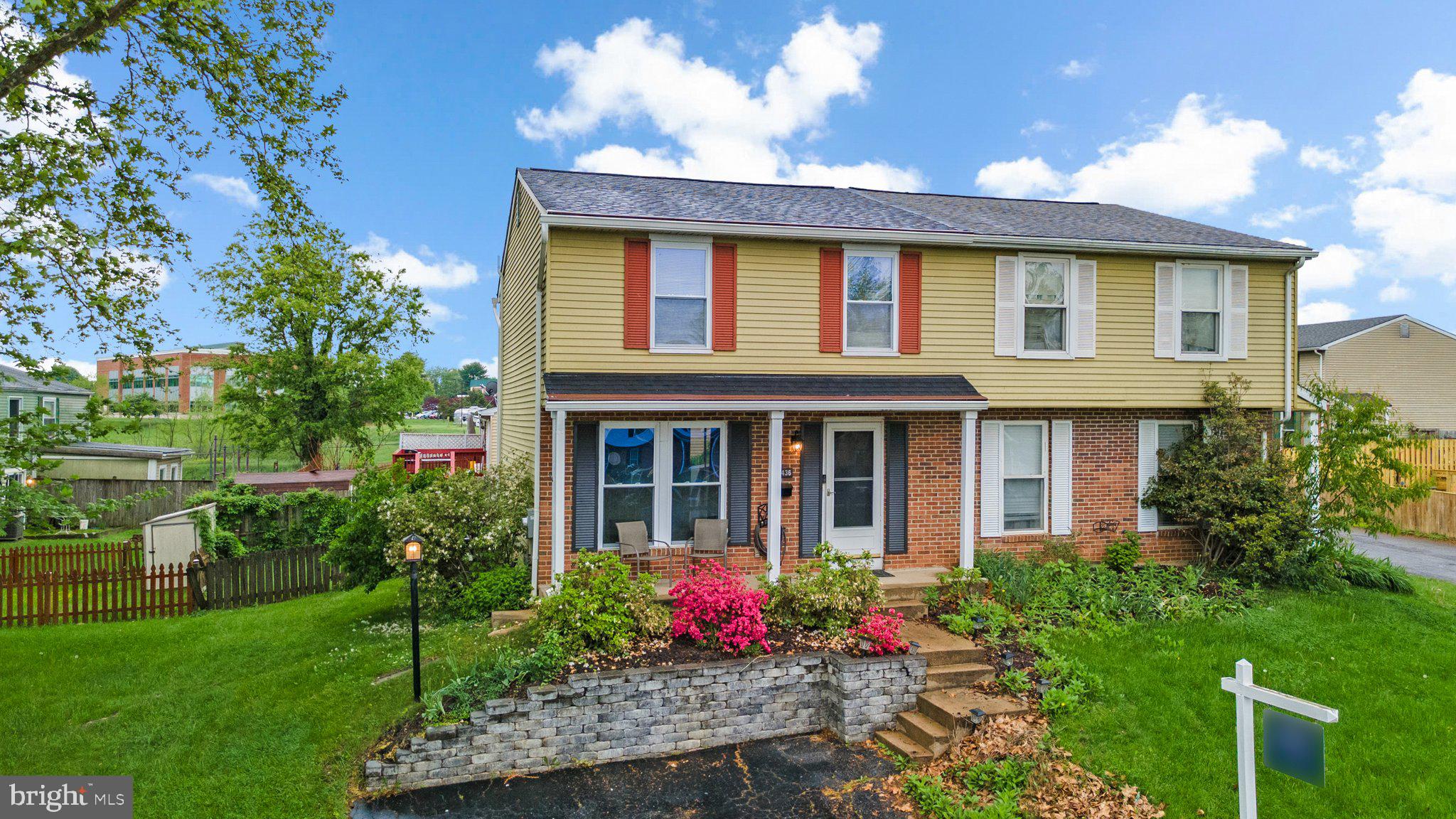 436 Heather Ridge Drive Frederick, MD 21702 - Photo 2 of 30 a view of a brick house with a yard and plants