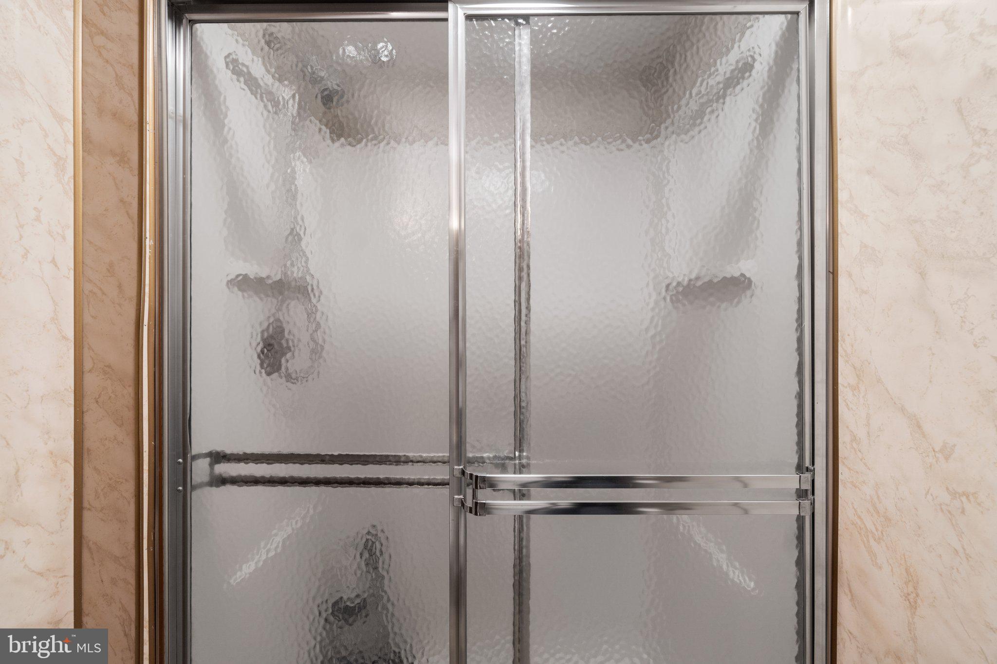 436 Heather Ridge Drive Frederick, MD 21702 - Photo 24 of 30 a bathroom with a glass shower door