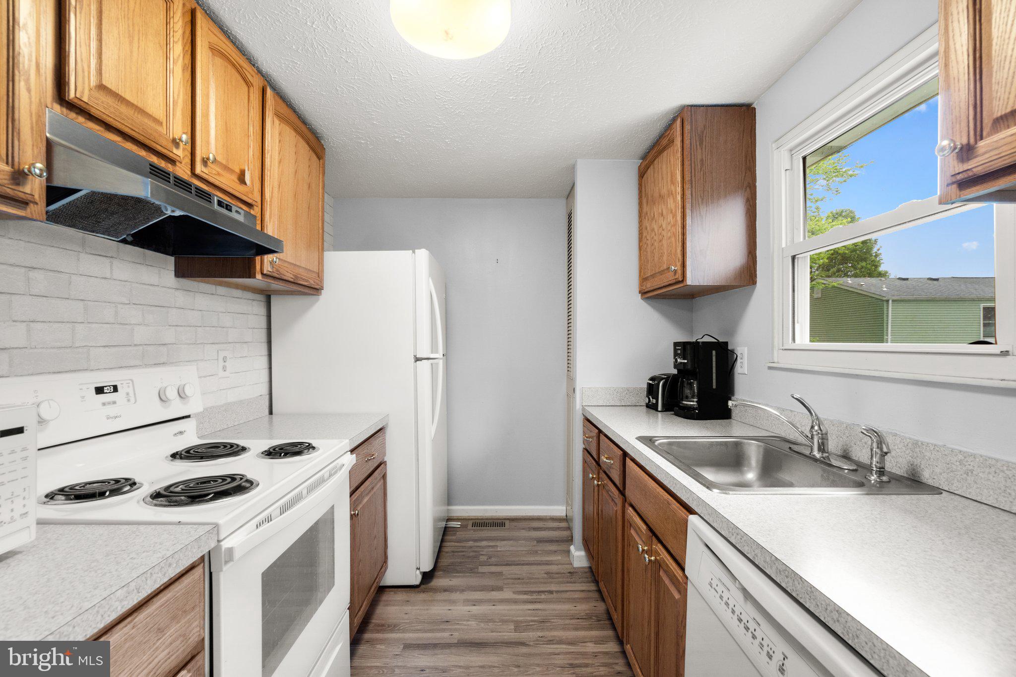 436 Heather Ridge Drive Frederick, MD 21702 - Photo 8 of 30 a kitchen with a sink a stove and a refrigerator