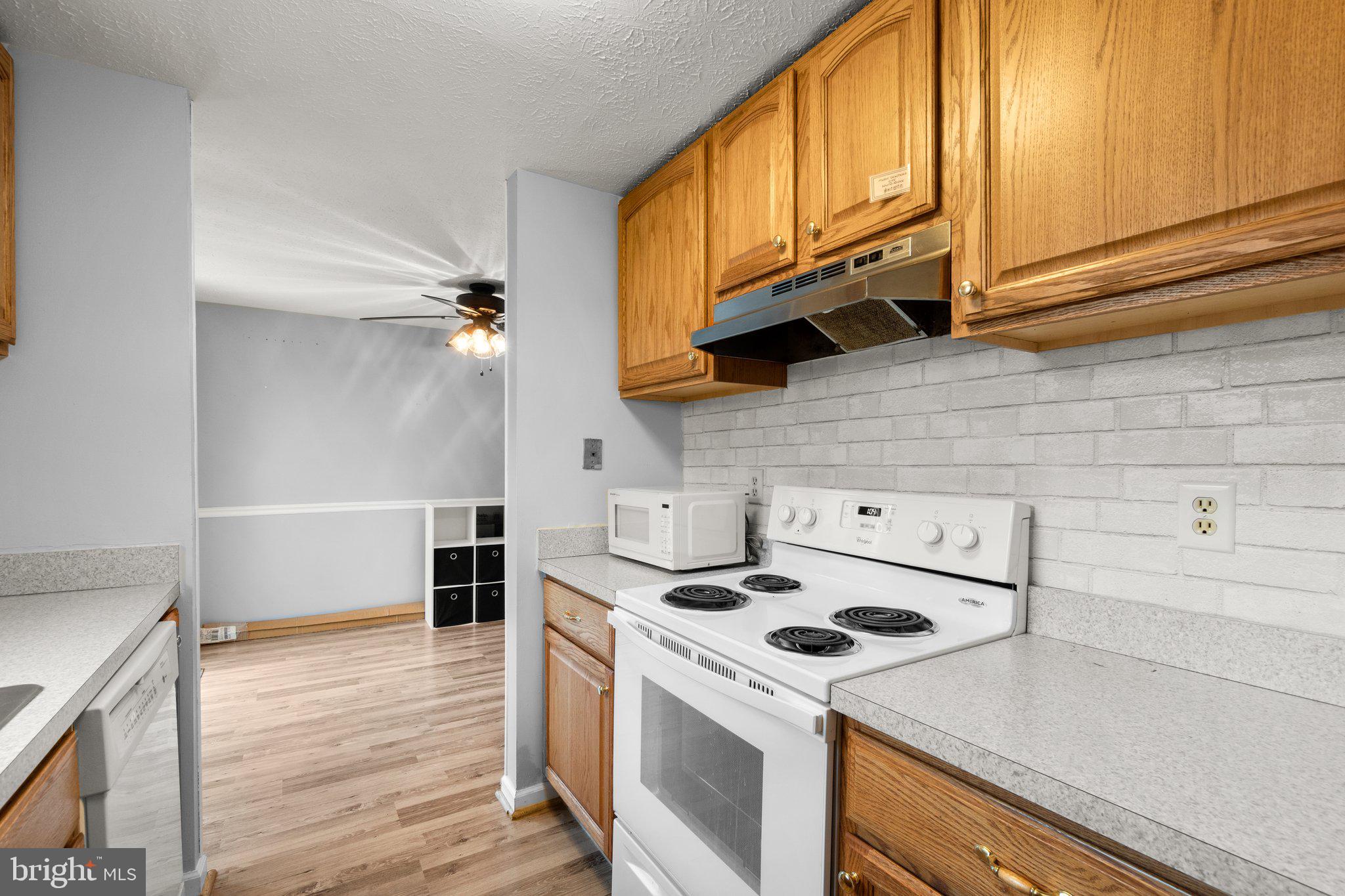 436 Heather Ridge Drive Frederick, MD 21702 - Photo 9 of 30 a kitchen with granite countertop a stove a sink and a microwave