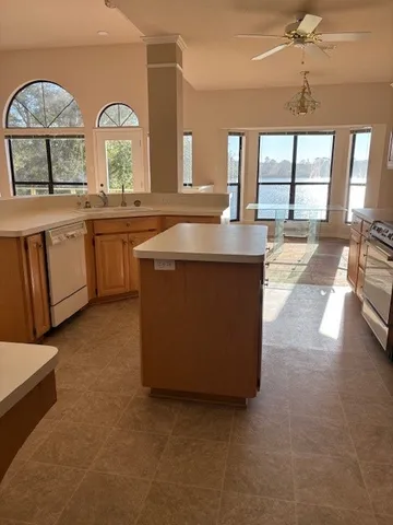 a view of a kitchen with a sink and a large window