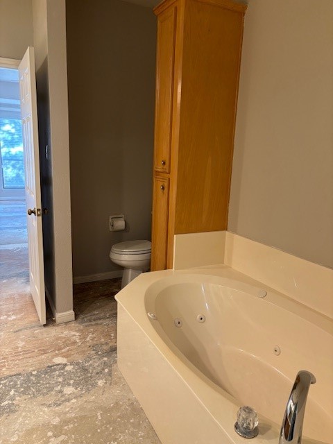 24 Lakeview Manor Huntsville, TX 77340 - Photo 17 of 26 a white bath tub sitting next to a toilet
