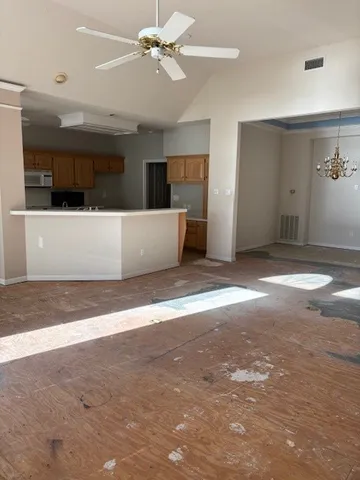 a view of a livingroom with a ceiling fan and window