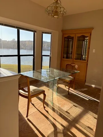 a room with gym equipment on the table and large windows