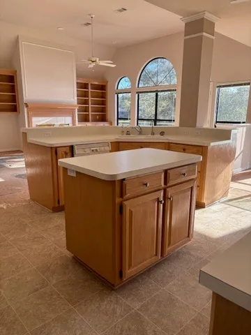 a view of a kitchen with a sink a fireplace and a large window