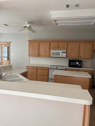 a kitchen with stainless steel appliances granite countertop a sink and a stove