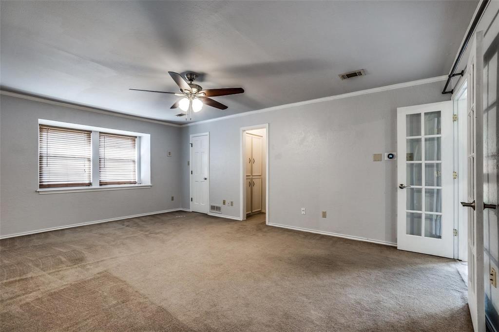 9911 Silver Creek Road Dallas, TX 75243 - Photo 16 of 28 Spacious room featuring neutral carpeting, a ceiling fan, and crown molding