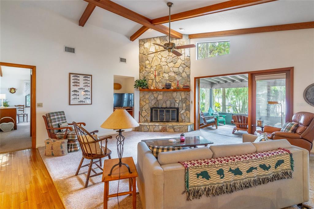 121 North Lake George Drive Georgetown, FL 32139 - Photo 15 of 46 a living room with furniture chandelier and a fireplace