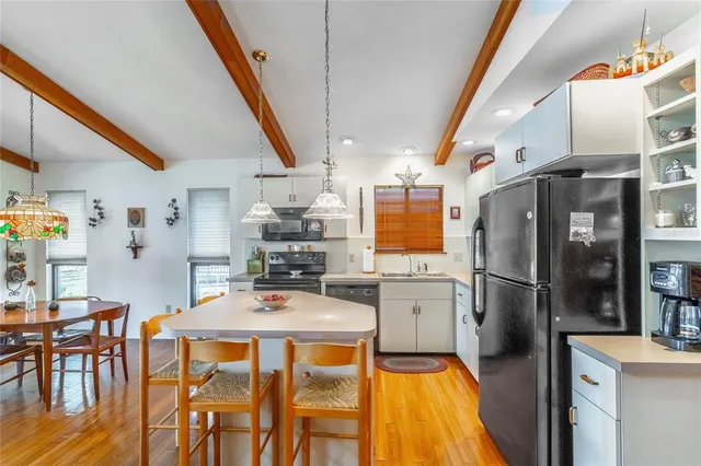 a dining room with furniture a window and wooden floor