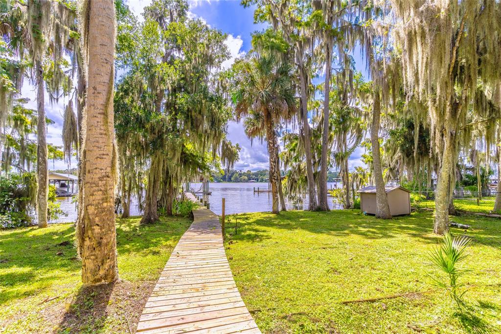 121 North Lake George Drive Georgetown, FL 32139 - Photo 30 of 46 a yellow house with trees in front of it