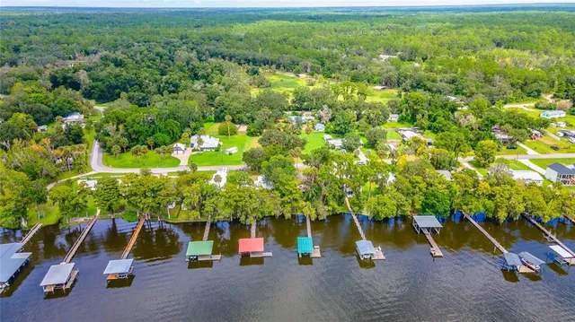 a living room with furniture a fireplace and a floor to ceiling window