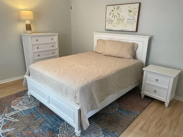 a bed room with a bed and a night stand